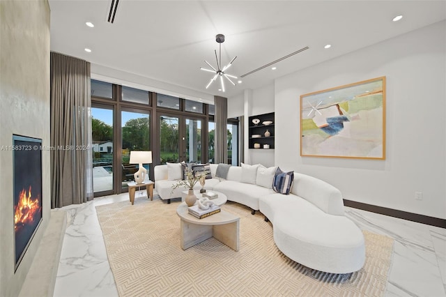 tiled living room featuring a premium fireplace, a wall of windows, and a chandelier