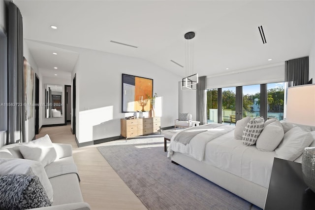 bedroom featuring french doors, hardwood / wood-style floors, and lofted ceiling