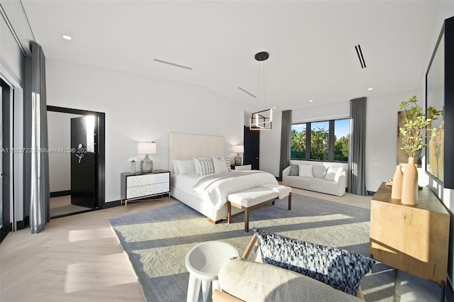 bedroom featuring vaulted ceiling and light parquet floors