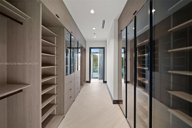 walk in closet featuring light parquet flooring