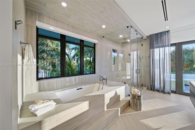 bathroom with plenty of natural light, vanity, and independent shower and bath