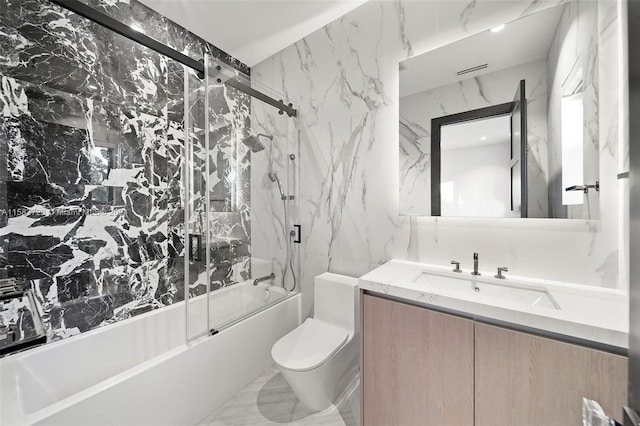 full bathroom featuring tile flooring, tile walls, combined bath / shower with glass door, vanity, and toilet