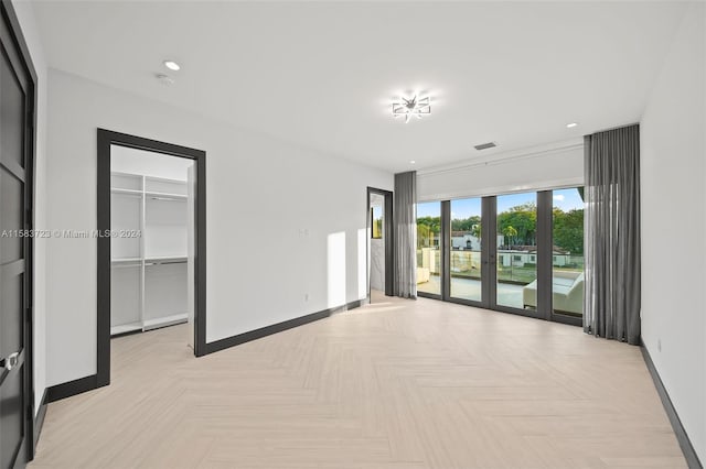 empty room featuring light parquet floors and french doors