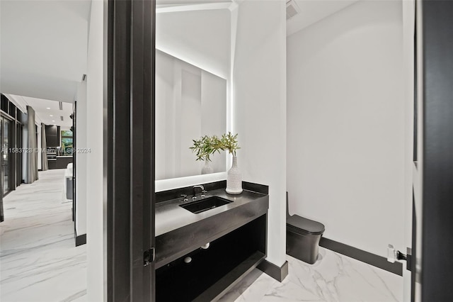 bathroom featuring tile flooring, toilet, and vanity with extensive cabinet space