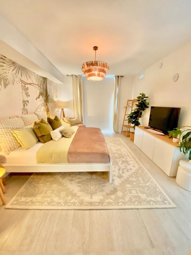 bedroom with a chandelier and hardwood / wood-style flooring