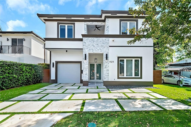 view of front of property with a front lawn, a garage, and a balcony