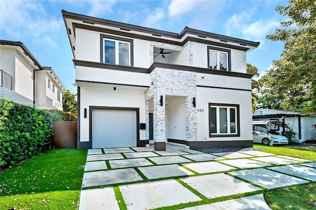 contemporary house featuring a garage and a front yard