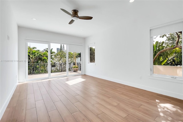 empty room featuring light hardwood / wood-style floors, plenty of natural light, and ceiling fan