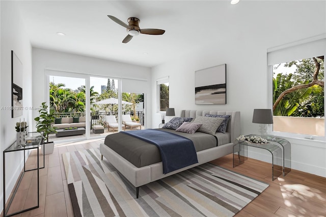 bedroom with ceiling fan, access to outside, and wood-type flooring