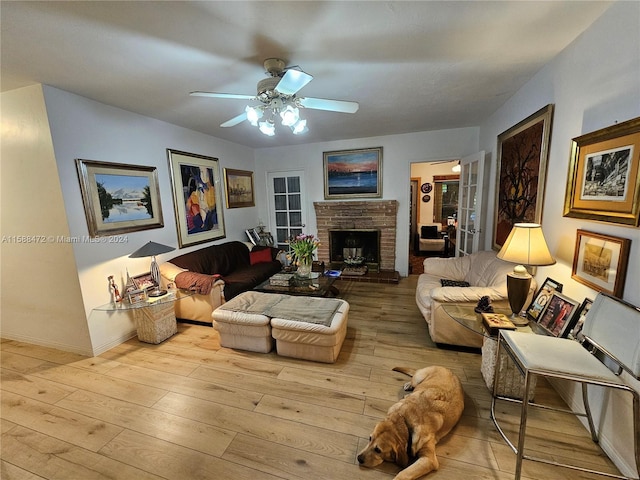 living room featuring a brick fireplace, ceiling fan, and hardwood / wood-style flooring