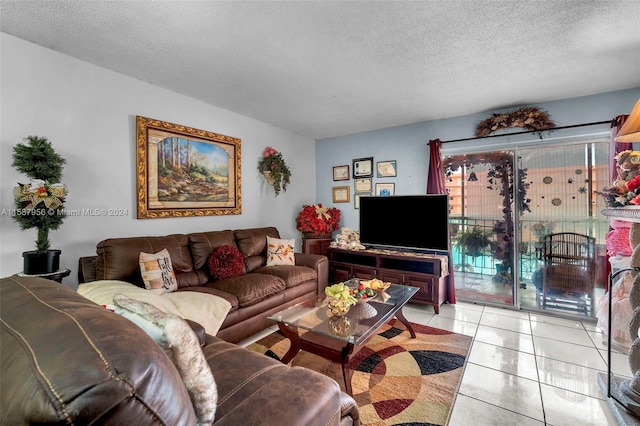 living room featuring light tile patterned floors and a textured ceiling