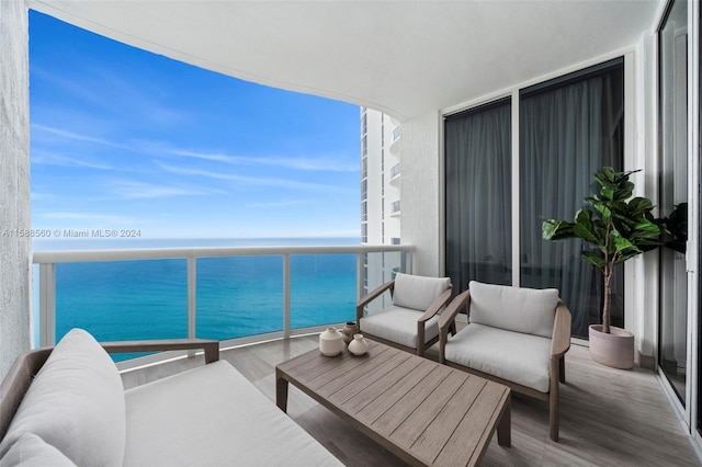 balcony featuring a water view and an outdoor hangout area