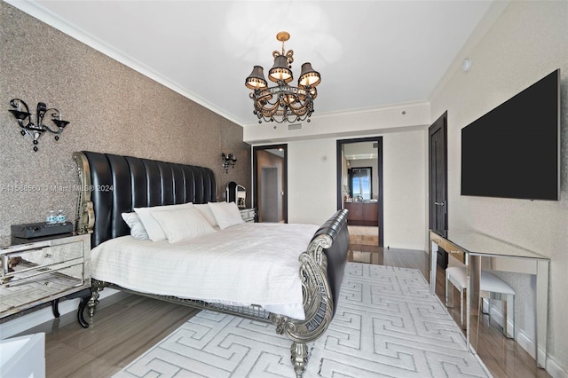 bedroom featuring an inviting chandelier, light wood-type flooring, and crown molding