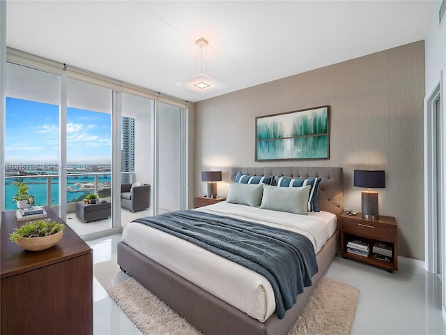 tiled bedroom with a wall of windows, access to exterior, and a water view