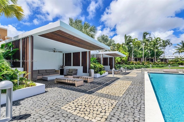 view of pool featuring a patio, ceiling fan, and an outdoor hangout area