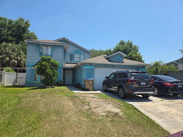 view of front of home featuring a garage and a front lawn