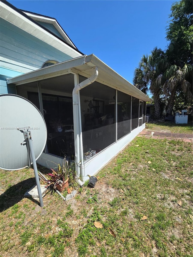 view of home's exterior with a sunroom