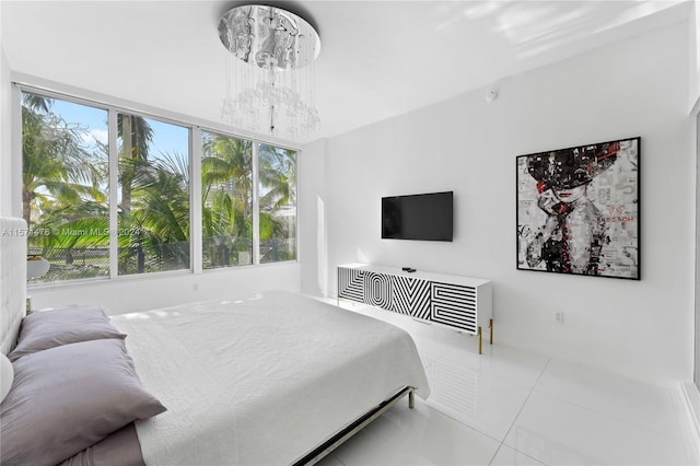 tiled bedroom featuring an inviting chandelier