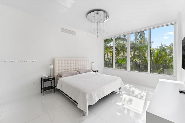 tiled bedroom featuring multiple windows