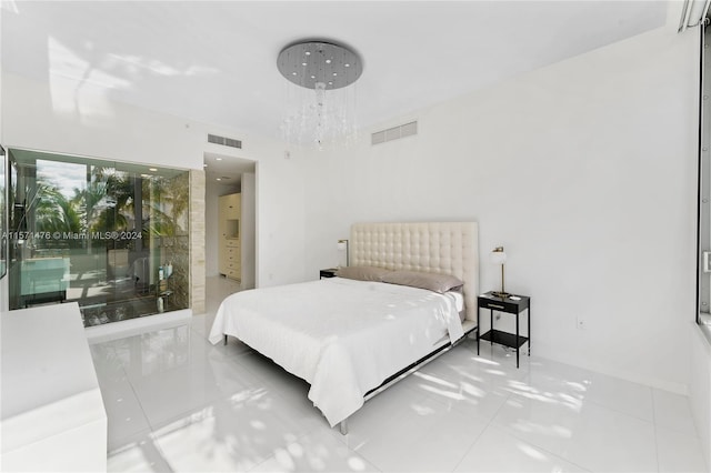 bedroom with tile floors and a chandelier