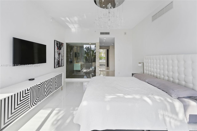 tiled bedroom featuring a notable chandelier