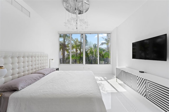 tiled bedroom with a chandelier