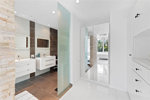 bathroom with walk in shower, tile flooring, and vanity