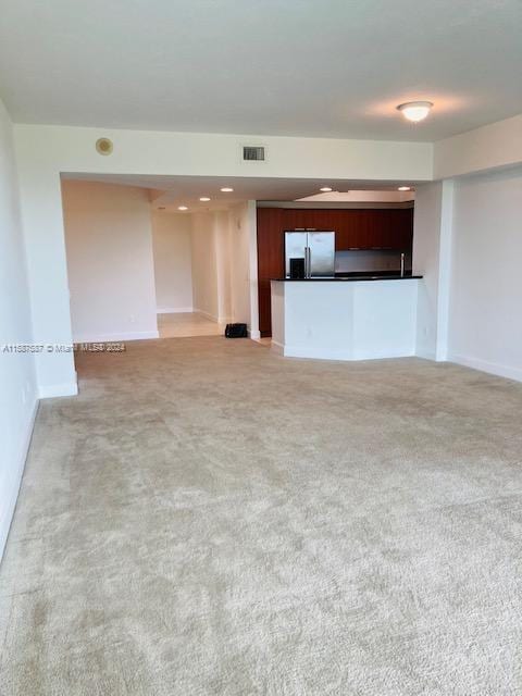 unfurnished living room with carpet