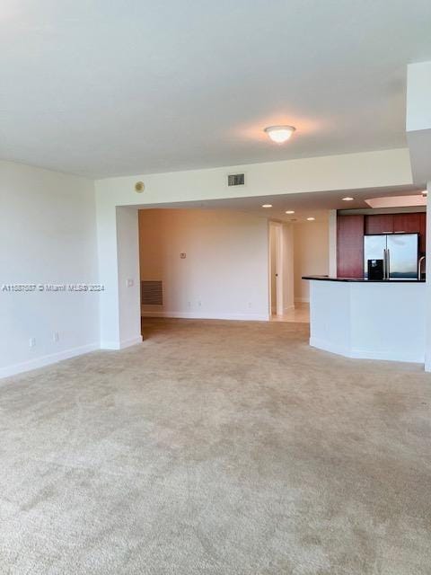 unfurnished living room featuring carpet floors