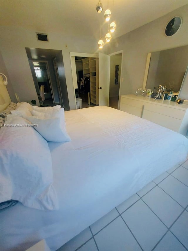 bedroom featuring tile flooring and a closet