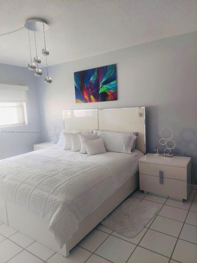 tiled bedroom with a textured ceiling