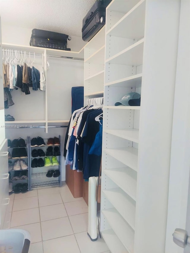 spacious closet with tile flooring