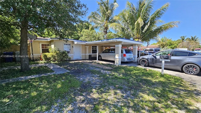 single story home featuring a carport