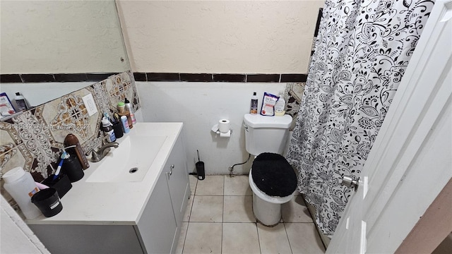 bathroom featuring tile floors, toilet, and vanity