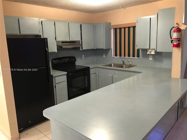 kitchen with light tile patterned floors, sink, gray cabinetry, a textured ceiling, and black appliances