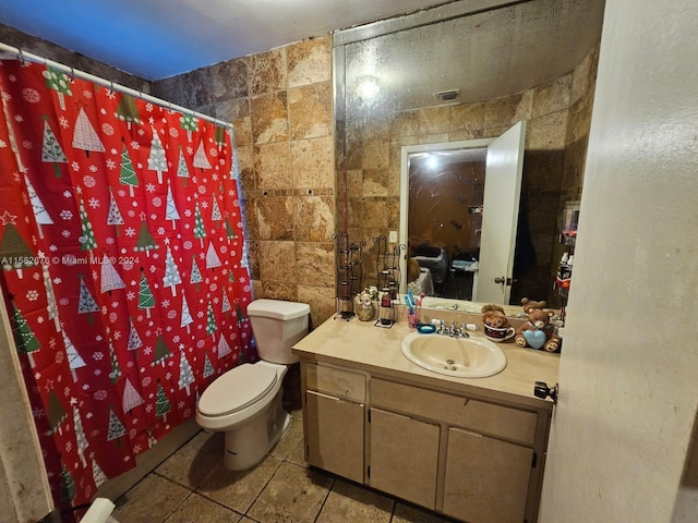 bathroom featuring tile walls, a shower with curtain, vanity, and toilet