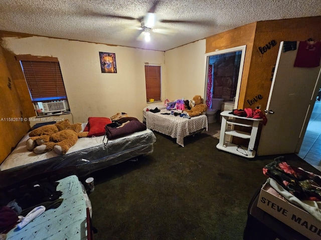 carpeted bedroom featuring ceiling fan, cooling unit, a textured ceiling, and ensuite bathroom