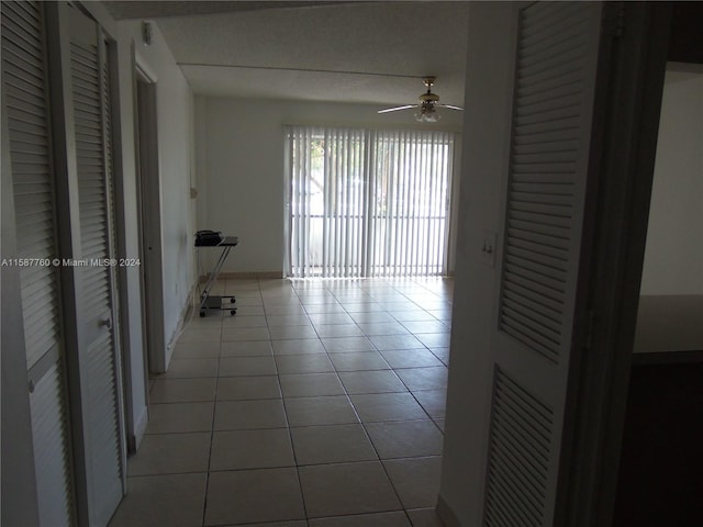 hall with tile floors