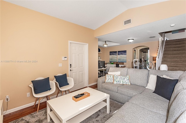 living room with hardwood / wood-style floors and lofted ceiling