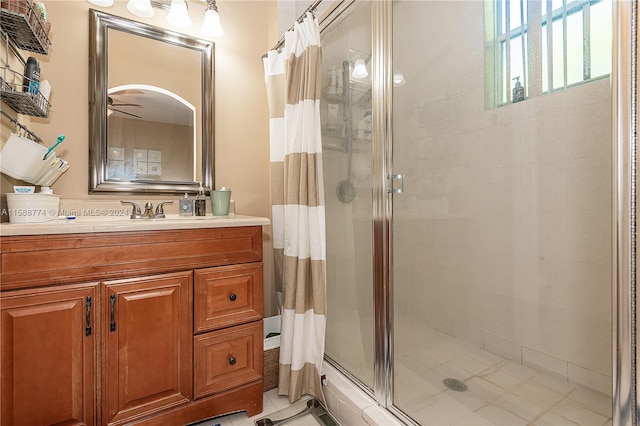 bathroom with vanity with extensive cabinet space, walk in shower, and tile floors