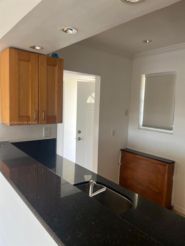 kitchen featuring dark stone countertops and sink