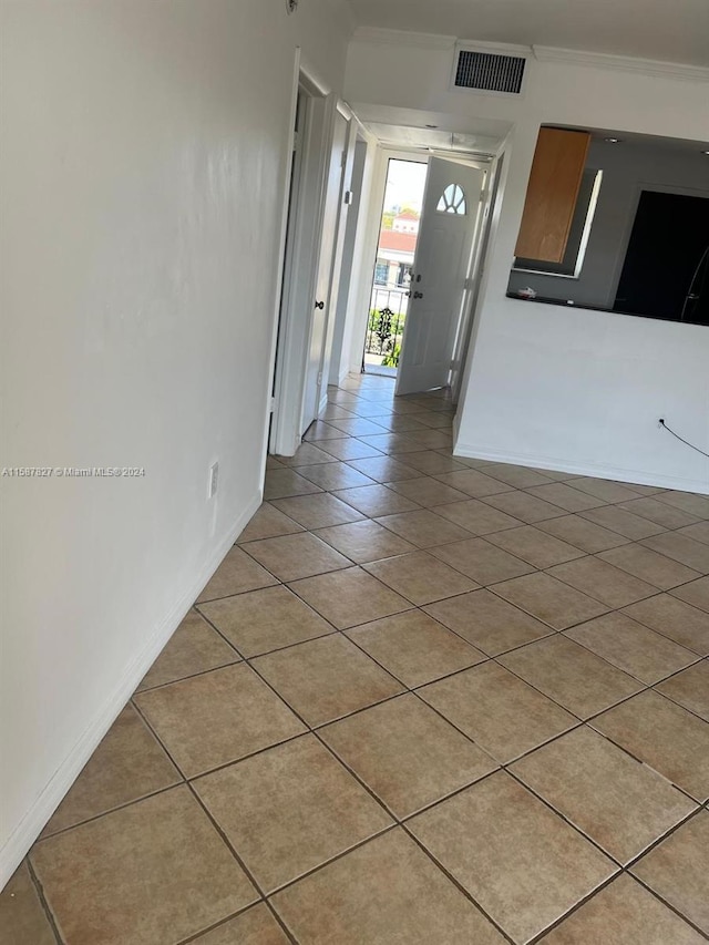 corridor featuring crown molding and tile flooring