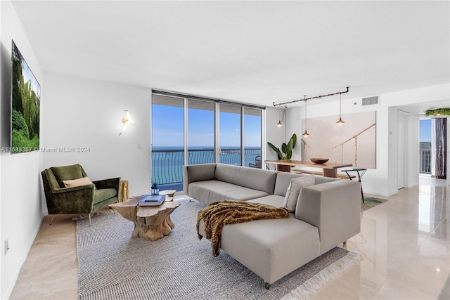 tiled living room with a water view and rail lighting