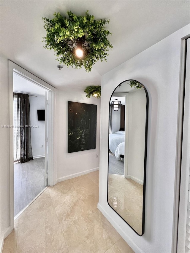 corridor with light hardwood / wood-style flooring