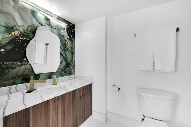 bathroom with tile floors, toilet, and vanity