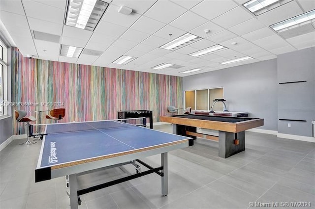 rec room with tile flooring, billiards, and a drop ceiling