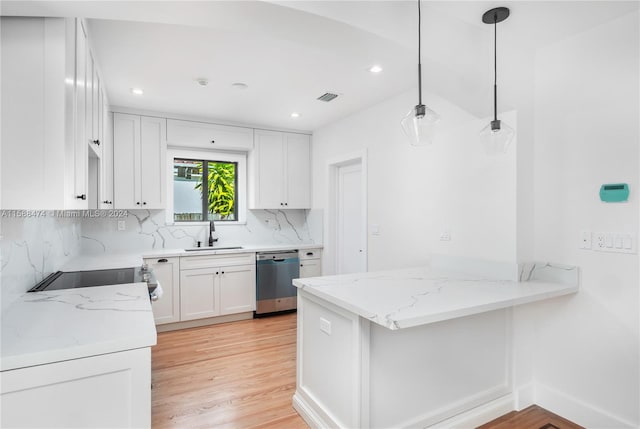 kitchen with light hardwood / wood-style floors, stainless steel dishwasher, hanging light fixtures, sink, and white cabinets