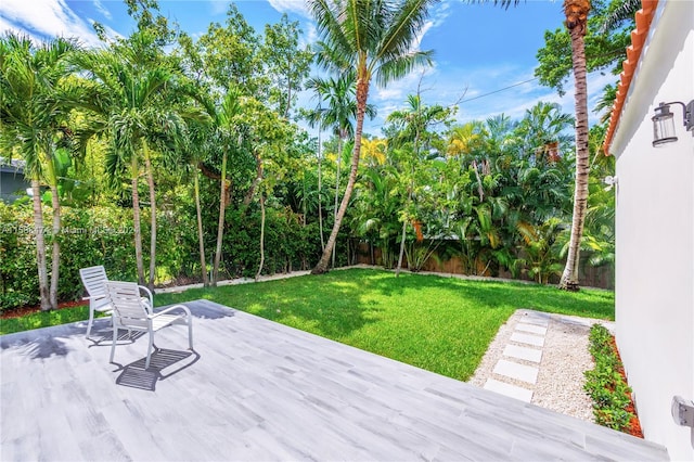 deck featuring a lawn and a patio