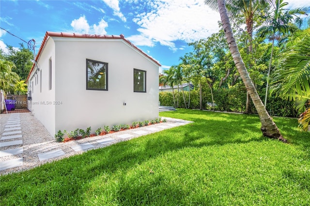 view of property exterior with a lawn