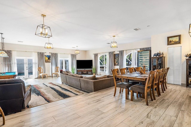 dining room with light hardwood / wood-style flooring and french doors